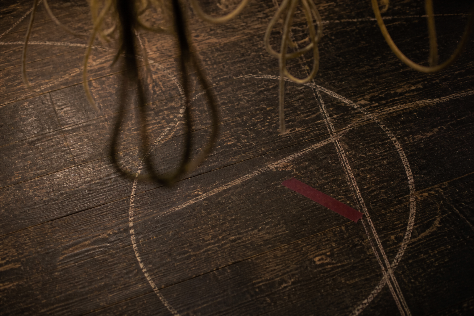 Scuffed dark floor with abstract chalk marks